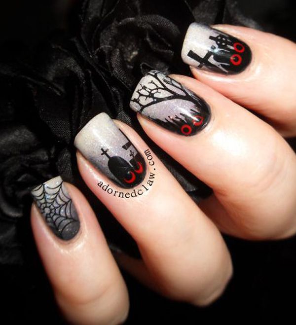 Hand with short nails with nail art of graveyard with red eyes and glittery fog sky.