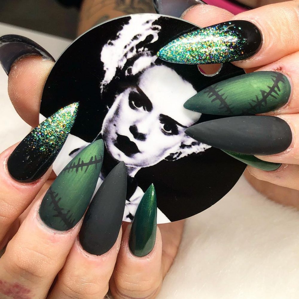 Long almond nails holding an image of Frankenstein. green with glitter