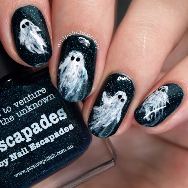 Short nails with drawing of ghost on each, on black glittery nail background